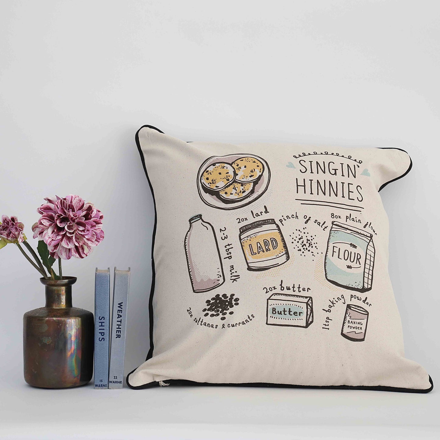 Cushion printed with ingredients for Singin’ Hinnies: flour, butter, dried fruit, milk.