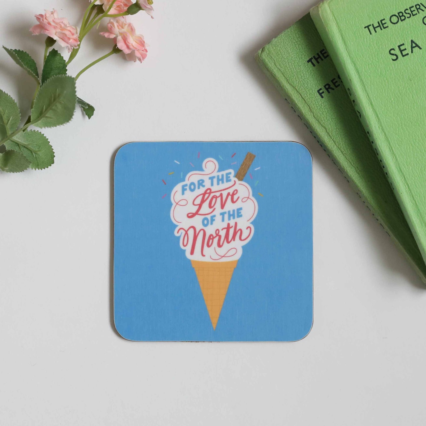 Coaster with a blue background and illustrated ice cream cone reading “For the Love of the North.”