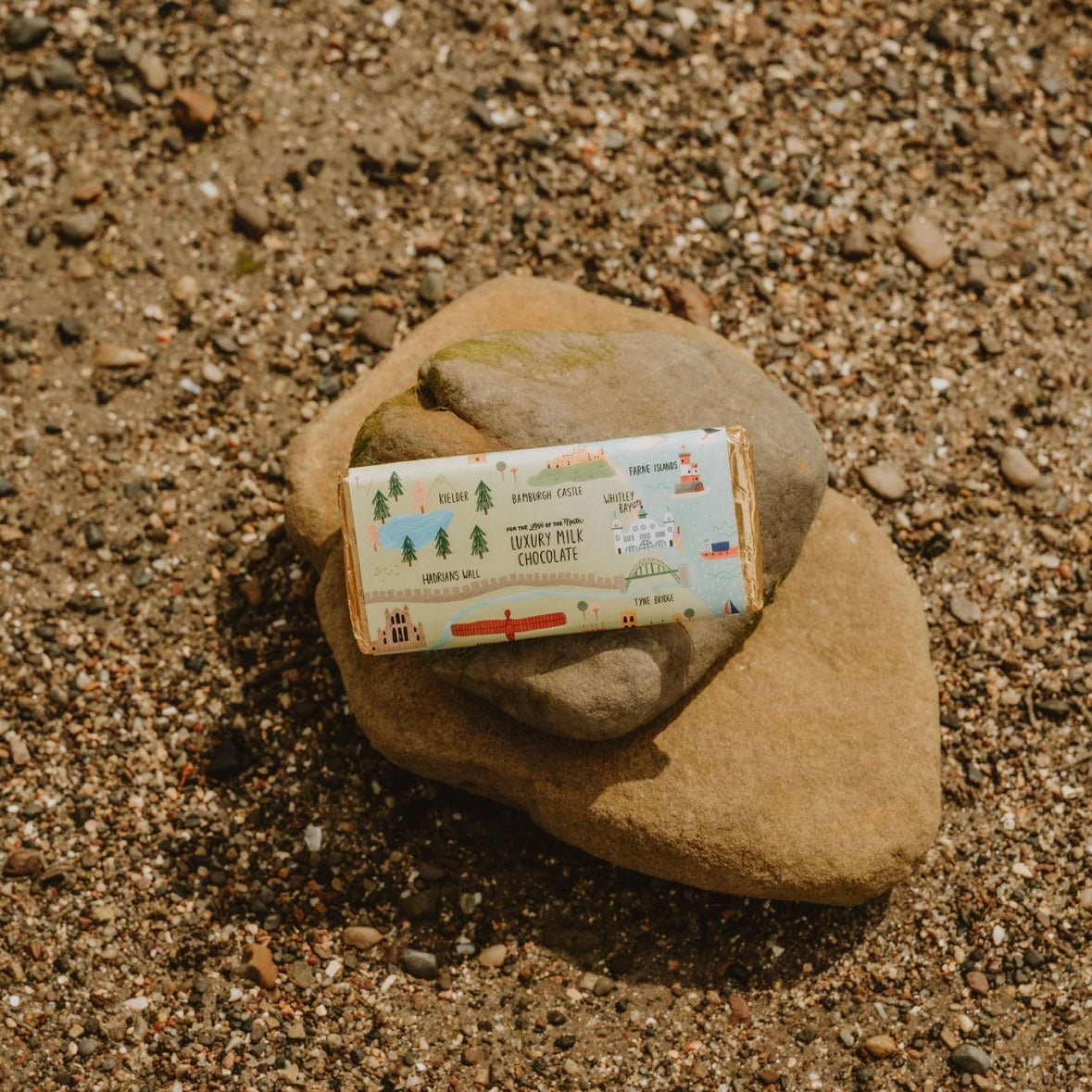 Chocolate bar on a rock with a scenic label in a natural setting
