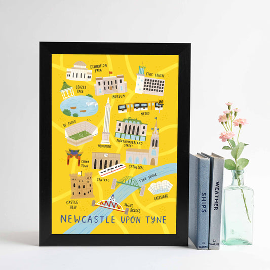 A framed print of Newcastle City Centre map, featuring iconic locations such as Tyne Bridge and Grey's Monument, displayed on a yellow background.